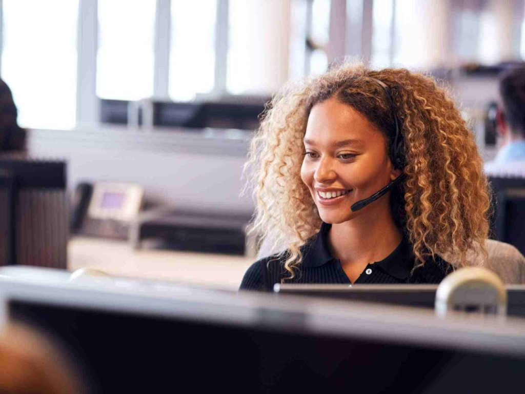 customer service agent smiling and talking on headset