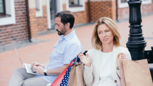 dissatisfied customer sitting with shopping bags